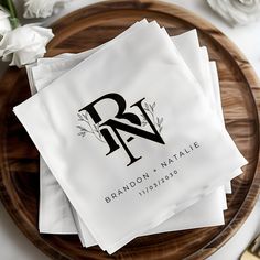 napkins with the letter r on them are sitting on a plate next to flowers