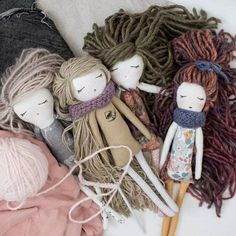 several dolls and yarns are laying on the floor next to each other in this image