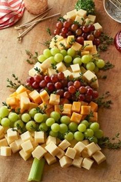 a christmas tree made out of cheese and grapes