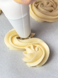 someone is decorating some cookies with icing