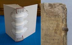 an open book sitting on top of a blue table next to a piece of paper