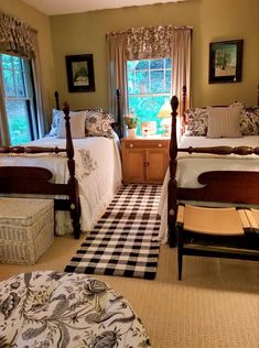 two beds in a room with checkered flooring