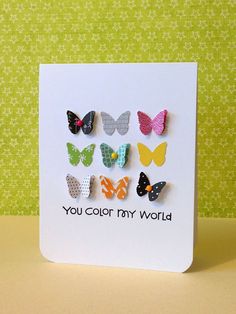 a card with four butterflies on it and the words you color my world written in black