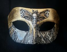 Silence EyeMask- Resin eyemask with black and white crackle, gold leaf, high gloss glaze, satin ribbons, an elastic band, and 3d hand painted Deathshead Moth. Finished interior with felt for comfort. Each piece is made by hand and are original pieces of art. Black And Gold Mask, Moth Mask, Deathshead Moth, Moth Costume, Gold Mask, 3d Hand, Satin Ribbons, Costume Mask, Art Original