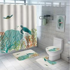 a bathroom with a shower curtain, toilet and rugs in the shape of sea animals