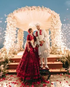 a man and woman standing in front of a decorated stage