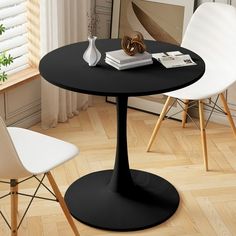 a black table with two white chairs next to it