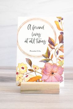 a card with flowers on it that says, a friend loves at all times