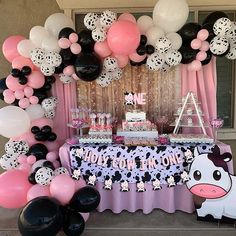 a birthday party with balloons, cake and decorations