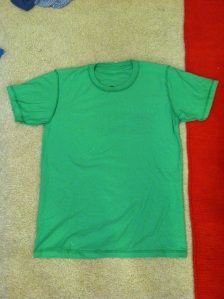 a green t - shirt laying on top of a red and white towel next to a pair of scissors