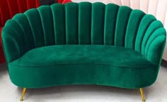 a green couch sitting on top of a white floor