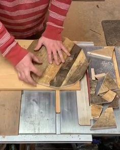 a person using a table saw to cut planks on a piece of plywood