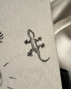 a drawing of a lizard on a white sheet