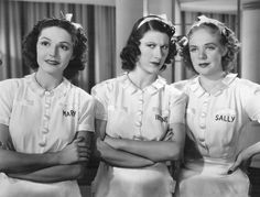 three women in white uniforms are posing for the camera with their hands on their hips