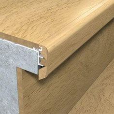 a close up view of a wood grained surface with an aluminum strip on the edge