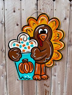 a wooden fence with a cartoon turkey holding a cup of ice cream