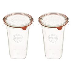 two glass jars with lids are sitting side by side on a white background, one is empty and the other has a brown lid