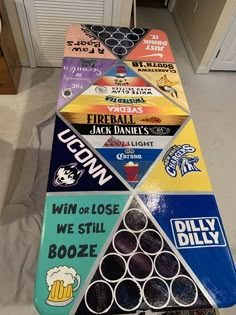 a long row of beer signs sitting on top of a floor next to a doorway