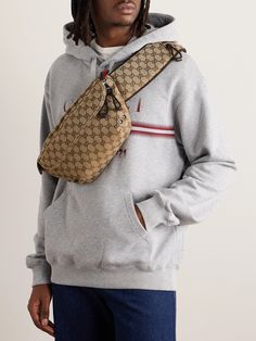 Gucci's 'GG' motif has been at the forefront of its collections since the early '60s. This belt bag is made from monogrammed canvas and has a padded strap with a polished silver buckle. Inside, there's room for everything you'll need on a day out, like your phone, wallet and sunglasses. Luxury Coated Canvas Belt Bag For Everyday, Designer Monogram Canvas Crossbody Belt Bag, Vintage Gucci Shoulder Bag With Removable Pouch, Brown Leather Gucci Belt Bag, Vintage Gucci Bag With Removable Pouch, Luxury Belt Bag With Removable Pouch In Coated Canvas, Classic Monogram Canvas Belt Bag With Removable Pouch, Gucci Brown Leather Belt Bag, Classic Monogram Canvas Belt Bag For Everyday