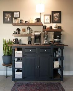 a coffee bar with lots of items on the shelves and below it is a potted plant