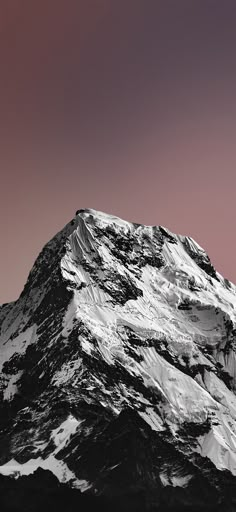 a snow covered mountain under a pink sky