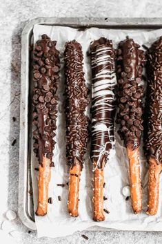 chocolate covered pretzels are lined up on a baking sheet