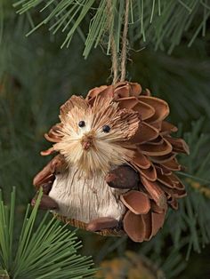 a pine cone ornament hanging from a tree