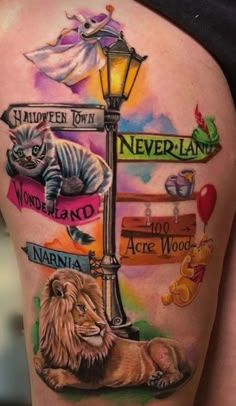 the back of a woman's thigh with many different tattoos on her legs and some cats