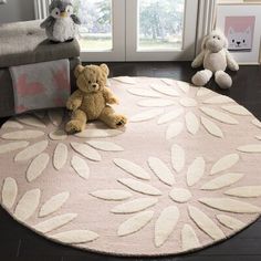 a teddy bear sitting on top of a rug in front of a window with stuffed animals