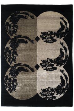 a black and white rug with four circular designs on the front, two in the middle