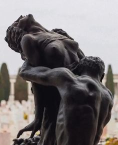 a statue is shown in the middle of a cemetery