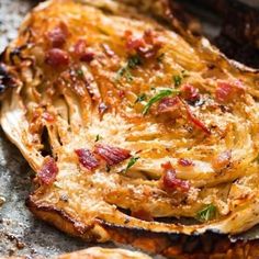 an omelet with bacon and cheese on it sitting on top of a table