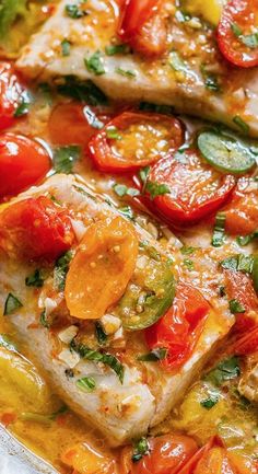 two fish fillets with tomatoes and green peppers