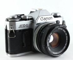 an old camera sitting on top of a white table