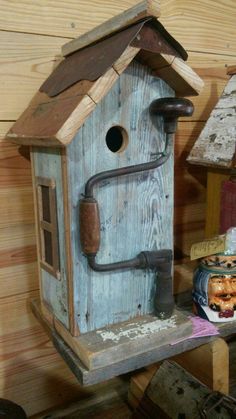 a birdhouse made out of wood and pipes