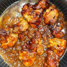 a pan filled with chicken and sauce on top of a stove