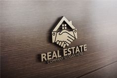 the real estate company logo is shown on a wooden surface, with two hands shaking each other