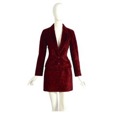 We present an exquisite and timeless Ozbek by Rifat Ozbek's vintage 1990s tailored jacket and mini low waist a-line skirt suit, made in a rich burgundy light cotton velvet, emulating faux Astrakhan fur. Made in Italy. The skirt and jacket are: Italian size 40 - French 36 - Usa 6 - GB 8 Measurements that are taken flat: Jacket: Ua to UA 18inch/46cm(x2) - Waist 15inch/38cm(x2) - Total Length 23inch/58cm - Sleeve 24inch/61cm Skirt: Waist 15inch/38cm(x2) - Hip 19inch/48cm(x2) - Total Length 13inch/3 Vintage Winter Skirt Suit For Formal Occasions, Vintage Long Sleeve Skirt Suit For Semi-formal Occasions, Fitted Vintage Burgundy Outerwear, Red Velvet Mini Skirt, Luxury Vintage Burgundy Outerwear, Vintage Red Blazer With Buttons, Mini Skirt Suit, Rifat Ozbek, Vintage Red V-neck Outerwear