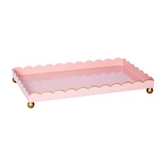 a pink tray with scalloped edges and gold trim on the bottom is shown