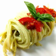 pasta with tomato sauce and basil leaves on top