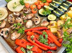 an assortment of vegetables on a tray ready to be cooked in the oven or grill