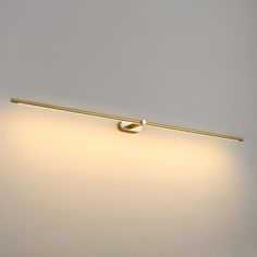 a light that is on the side of a wall with a long rod attached to it