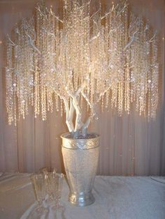 a silver vase filled with lots of white flowers