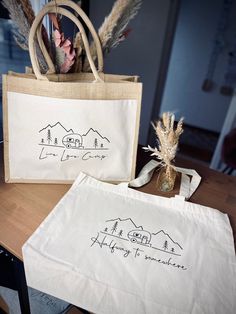 two bags sitting on top of a table next to each other with writing on them