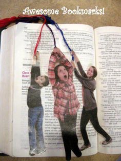 an open book with pictures of children hanging from it's sides and on the pages