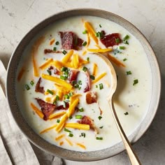 a bowl of soup with bacon and cheese