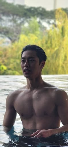 a man standing in the water with no shirt on