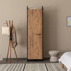 a wooden cabinet sitting next to a bed on top of a rug in a room