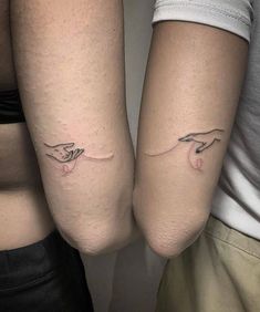 two people with matching tattoos on their arms