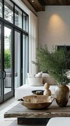 a living room filled with lots of furniture and large vases on top of a coffee table